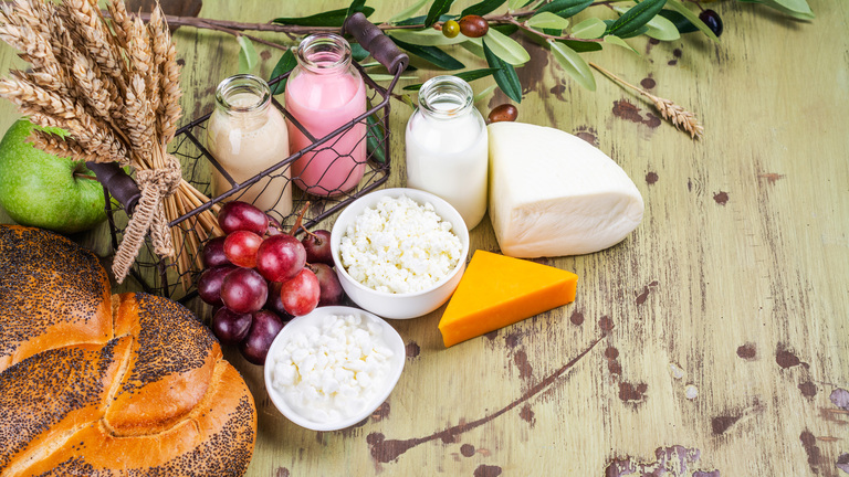 Milk, bread, fruits and dairy products on wooden table