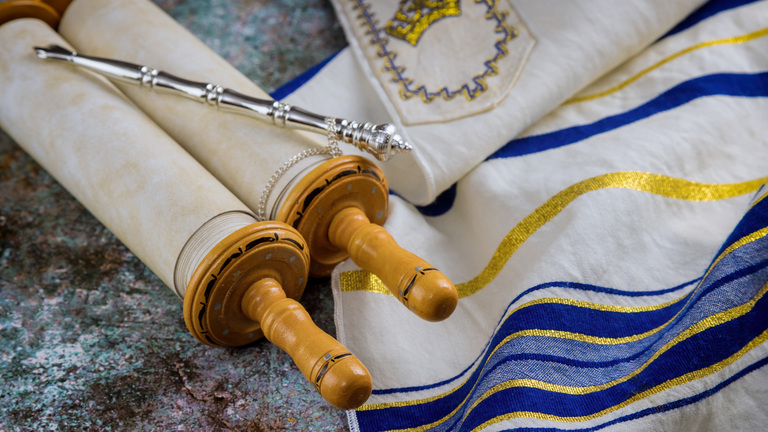 Prayer shawl (tallit) with Torah scroll in a synagogue