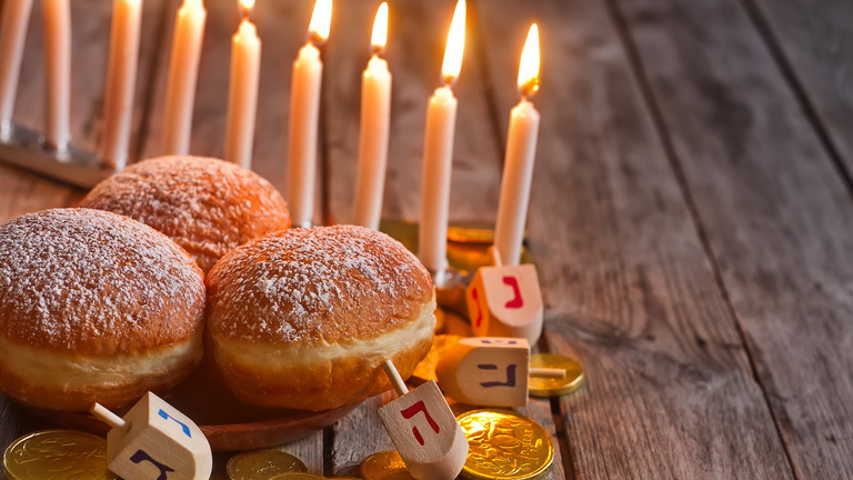 Menorah, doughnuts, chocolate coins and wooden dreidels